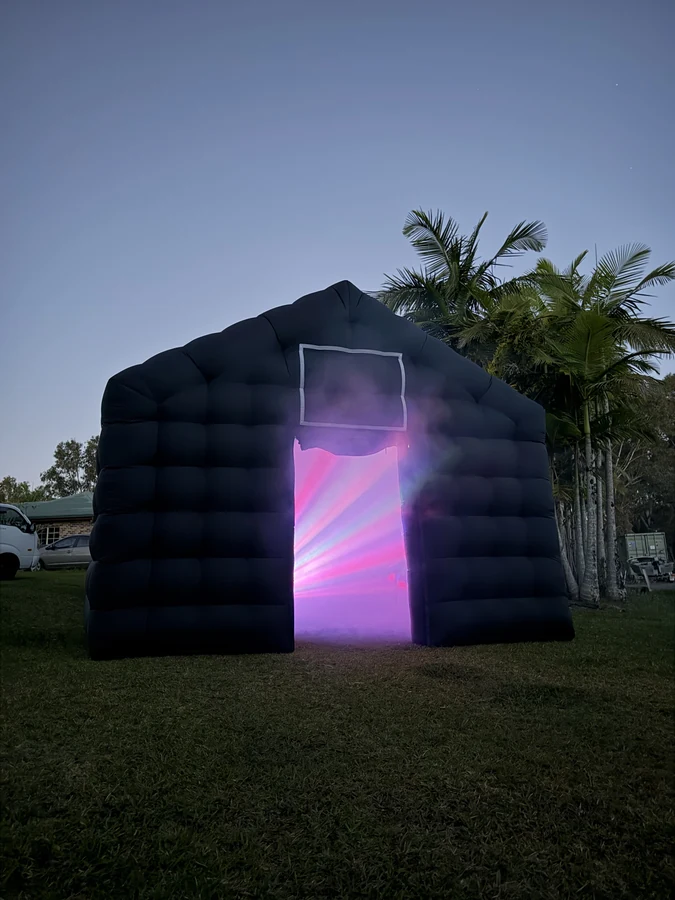 Cove Events black inflatable nightclub with party lights set up on a lawn